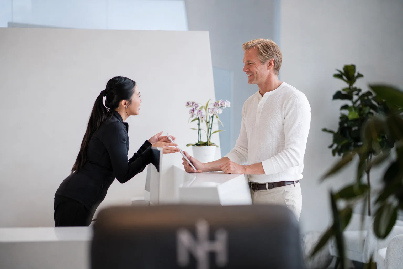 Next Health front desk team member welcoming a patient
